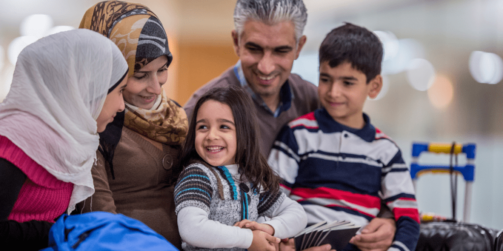 Image of smiling family resettling in a new country