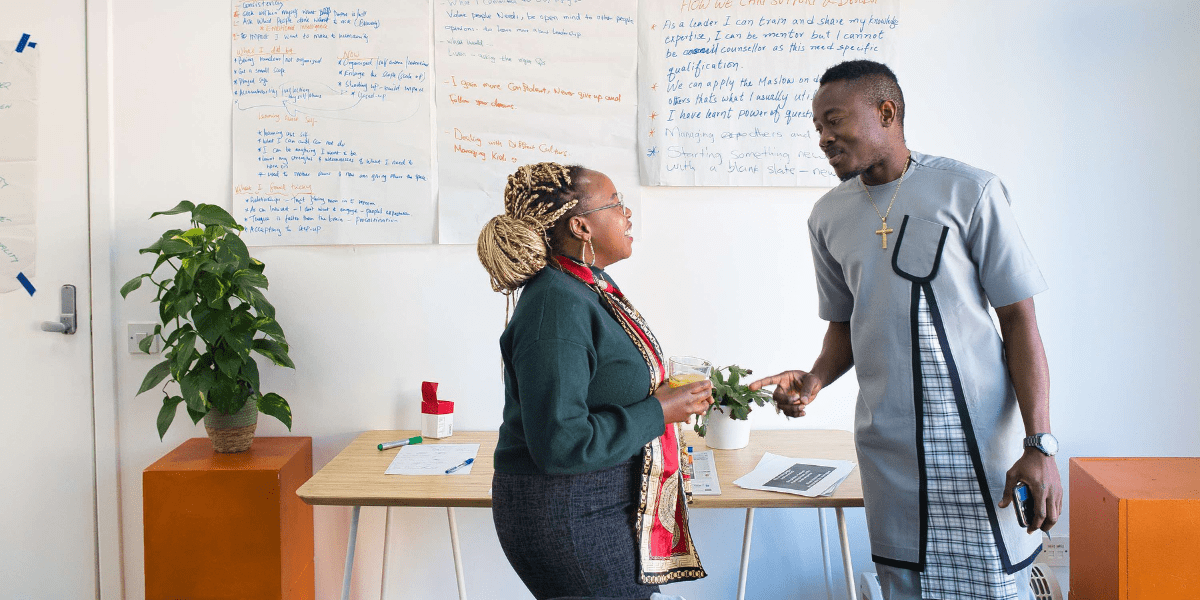 Two leaders, Anne and Isaac, talking during a Leadership workshop.