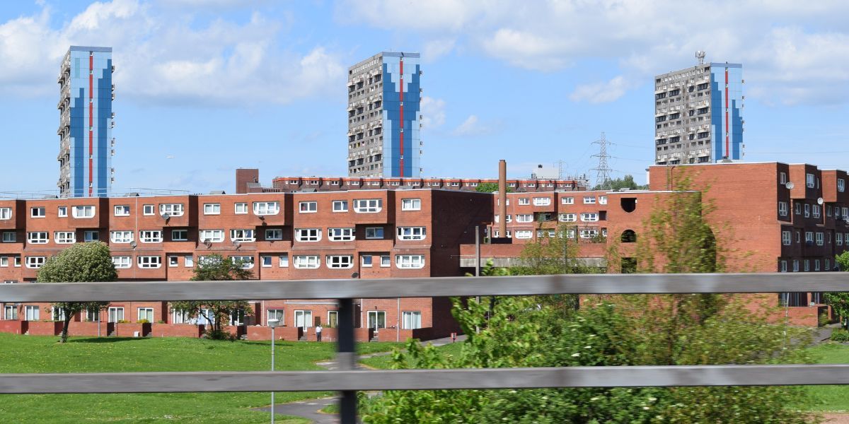 Glasgow skyline showing high rise flats behind a lower block of housing